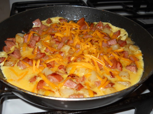 Sprinkle with cheese, then cover and let cook until eggs are done to your taste